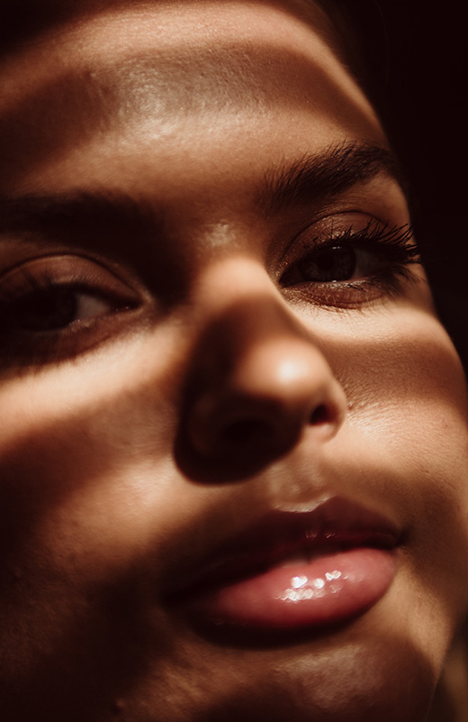 Close-up of woman’s face highlighting smooth skin and natural facial contours