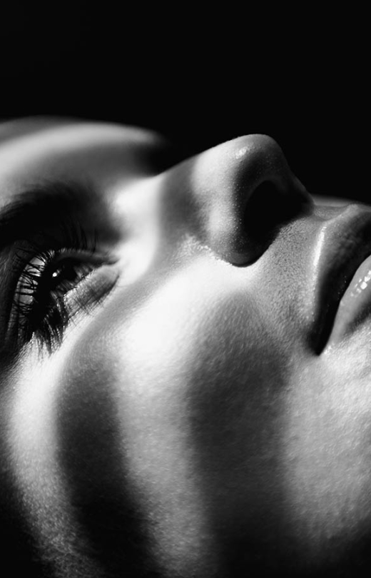 Close-up of woman's face highlighting smooth skin texture and facial contours