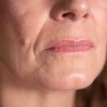 Up close photo of womans chin and lips